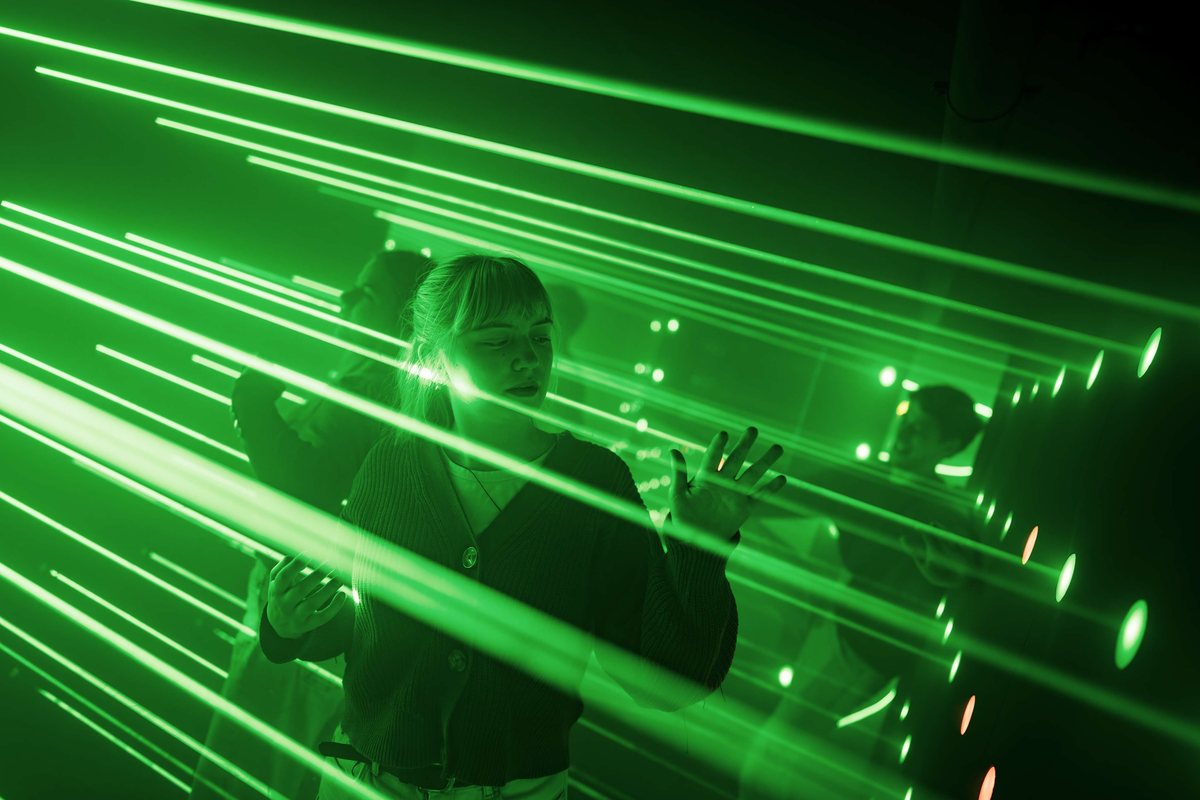 Two colleagues moving through the DODGE laser course during social games in Utrecht